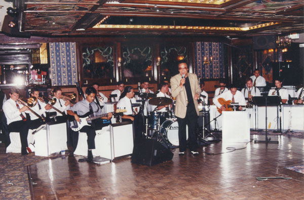 A man is standing in front of a group of people.